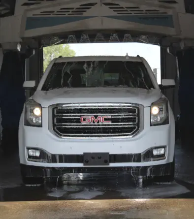 SUV going through an automatic car wash at Champions Car and Truck Wash